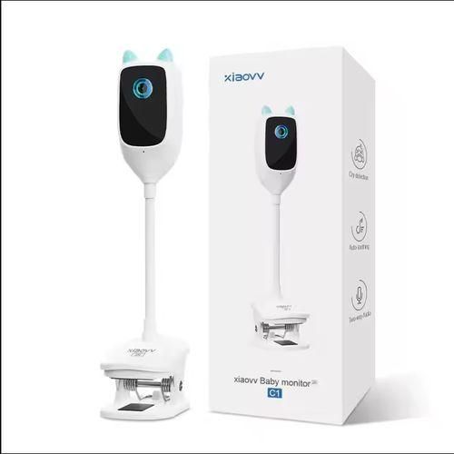 White baby monitor with blue accents on a white background, next to its packaging box.